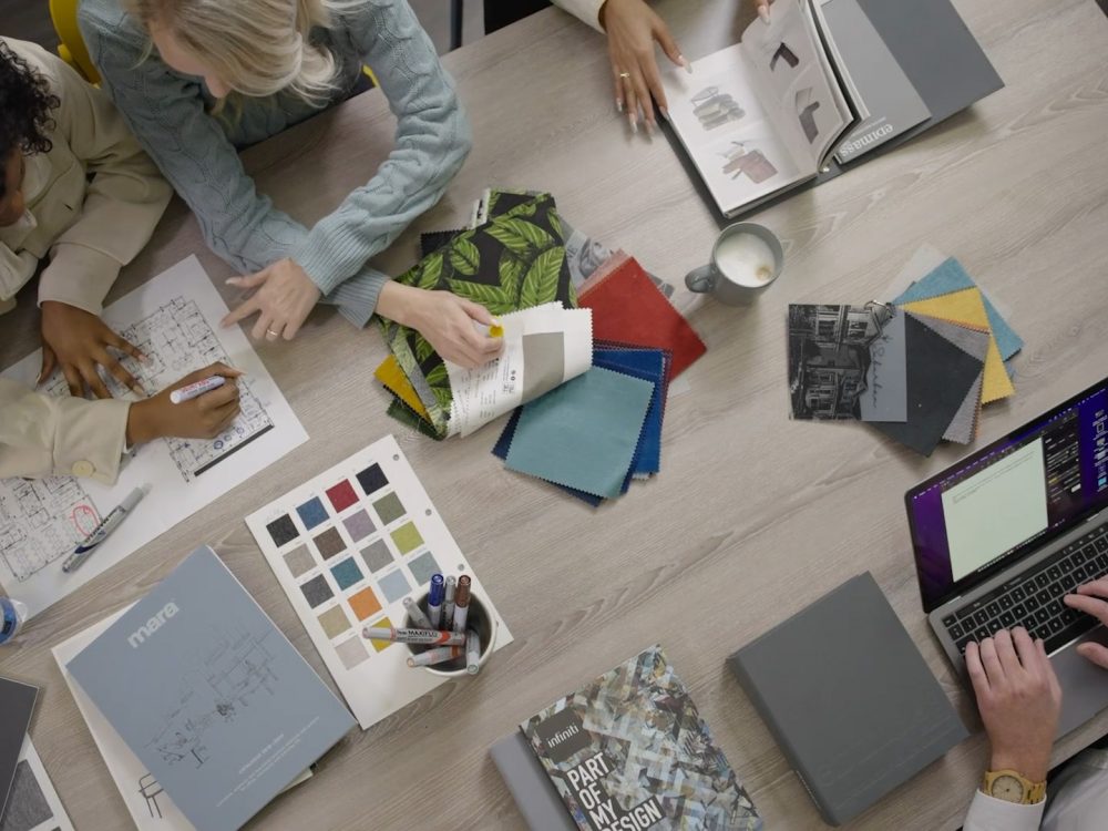 Group of people sitting and working on office design services